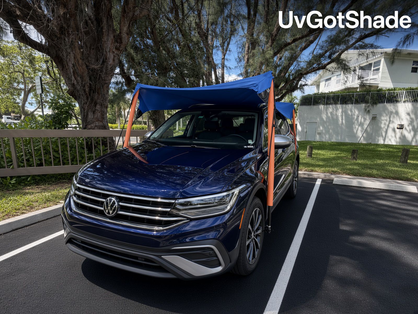 UVgotshade canopy over a navy SUV in a parking space
