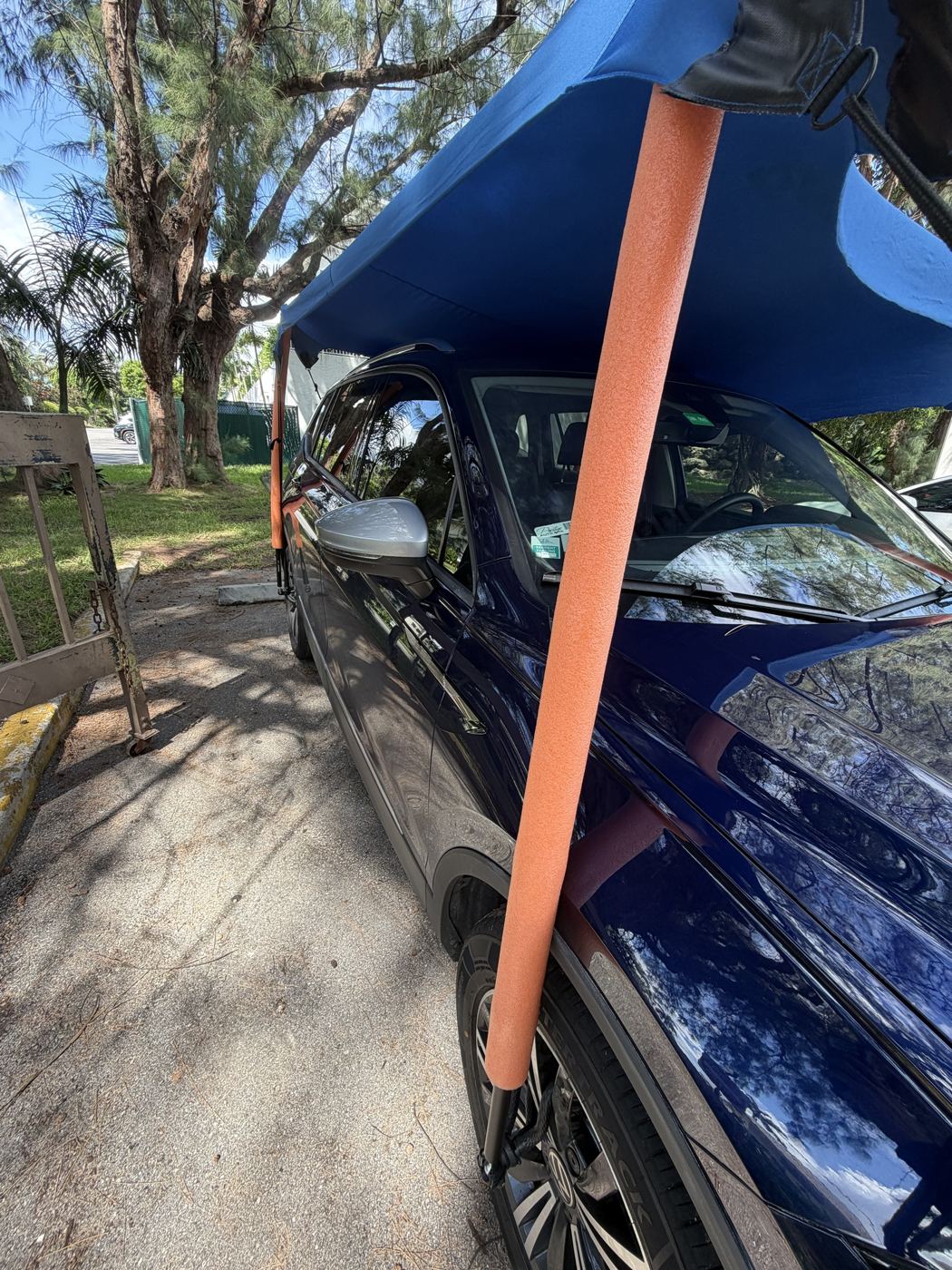 Telescopic aluminum pole with orange foam sleeve rising from the front wheel mount